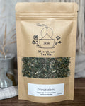 Kraft paper tea bag from Merryheart Tea Hut with tea leaves visible on a neutral background
