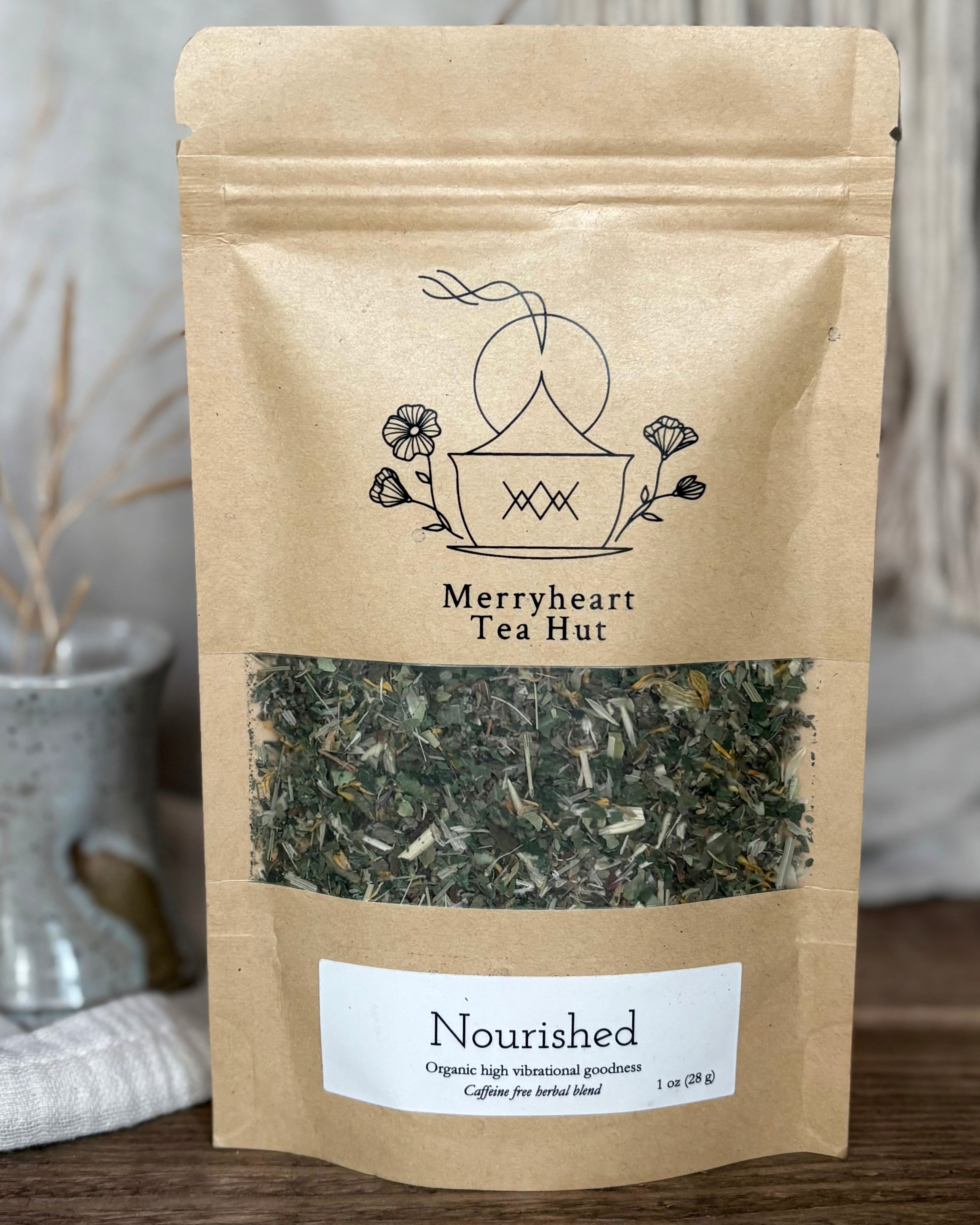 Kraft paper tea bag from Merryheart Tea Hut with tea leaves visible on a neutral background
